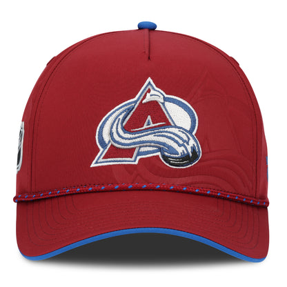 Front view of a  Burgundy Hat with Avalanche Logo in center with a larger Avalanche tonal logo behind main logo, blue Fanatics logo on front left  panel, burgundy rope with blue diamonds.  Bottom bill has blue