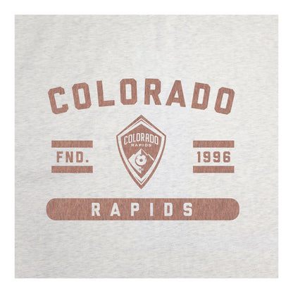 A close up view of a light oatmeal colored blanket featuring a distressed brown Colorado Rapids graphic print, shown against a plain white background.
