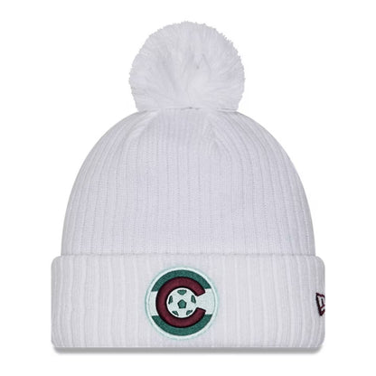 White knit beanie with pom-pom and logo on a white background