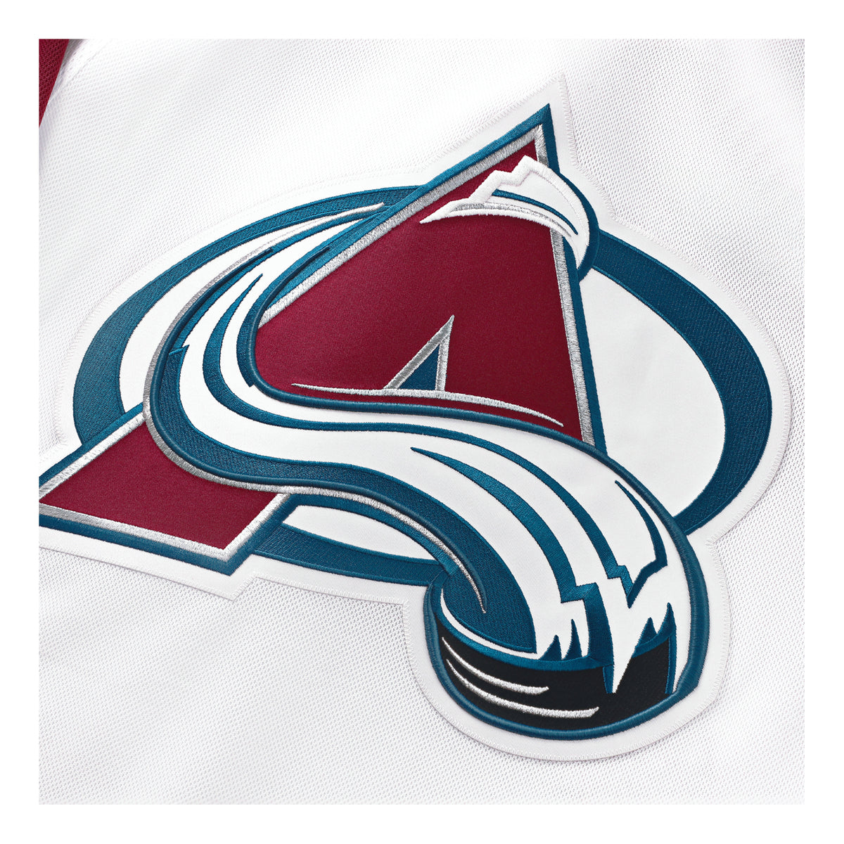 Close-up of the Colorado Avalanche embroidered Primary logo patch on a white jersey.