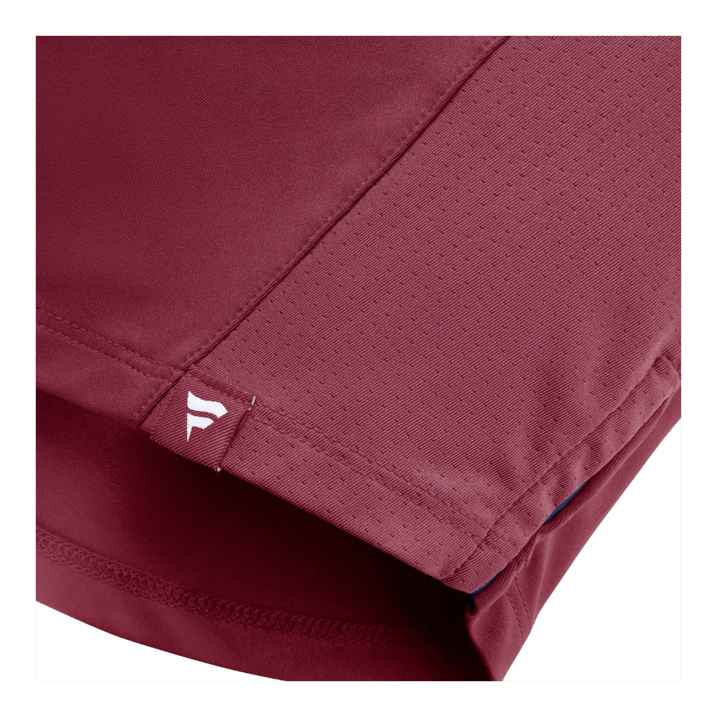 Close-up of a burundy t-shirt showing the fabric texture, stitching, and a small white Fanatics logo on a tab near the hem.
