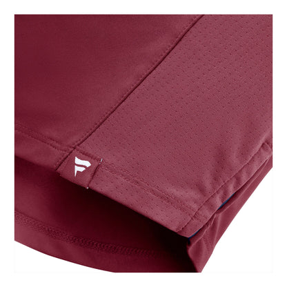 Close-up of a burundy t-shirt showing the fabric texture, stitching, and a small white Fanatics logo on a tab near the hem.